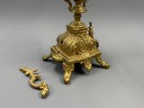 a gold vase and a key on a table