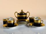 several cups and saucers are sitting on a white table