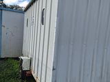 a small trailer that is parked next to a building