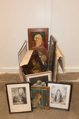 a pile of framed pictures on the floor next to a pile of framed pictures