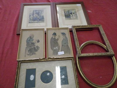 many framed pictures on a table with a red table cloth