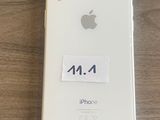 an iphone with a sticker on it sitting on top of a wooden table
