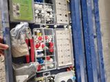 a man that is standing next to a box with many items