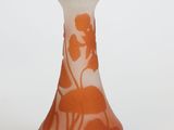 a small vase with an orange and white design on it