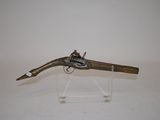 an old gun with a wooden handle on a clear stand