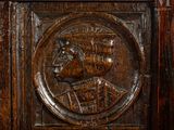 a carved wood panel with a picture of a man on it