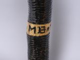 a close up of a black and gold pen with a name on it