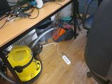 a desk with a computer and a vacuum on it