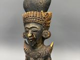 a close up of a statue of a woman with a hat on her head