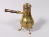 an antique brass teapot with a wooden handle on a white background