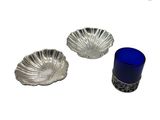 trois morceaux de verre argenté et bleu sur un fond blanc