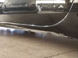a car that is parked in a garage with its door open