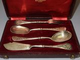 silverware in a red case on a table with a red cloth