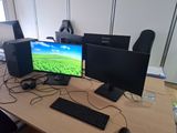 a desk with two computer monitors and a keyboard on it