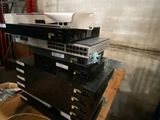 a stack of electronics sitting on top of a wooden table