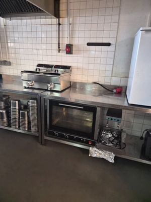 a kitchen with a stove, oven, and refrigerator in it