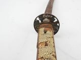 a close up of a sword with pearls on it