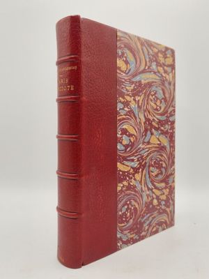un livre rouge orné de motifs dorés et bleus