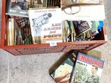 many books in a red box on the floor