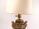 a lamp that is sitting on a table with a lamp shade on it