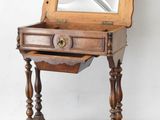 a small wooden table with a mirror on it