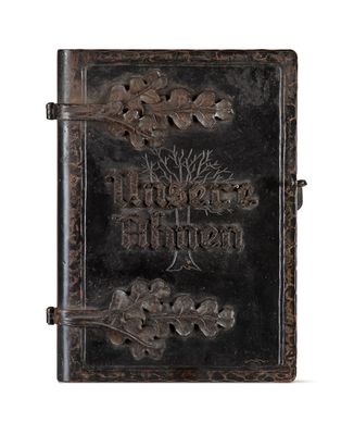an old book with a tree on the front cover