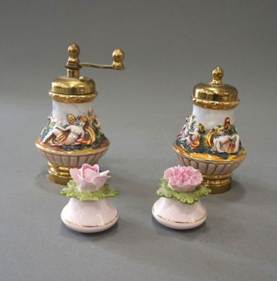 two salt and pepper shakers sitting on a table