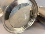 a silver cup with a lid sitting on a table