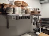 a kitchen with a microwave, toaster, toaster and other items on the shelves