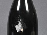 bottles of wine are lined up on a table with a gray background
