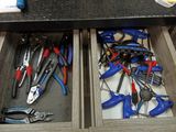 many tools in the drawer of a workbench