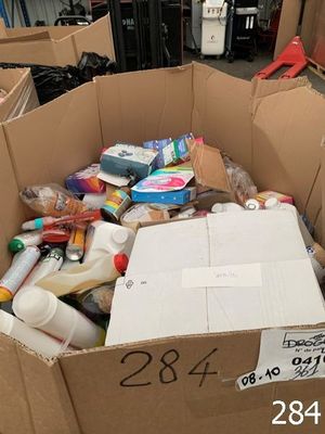 a cardboard box filled with assorted items in a warehouse