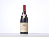 a bottle of red wine sitting on top of a table