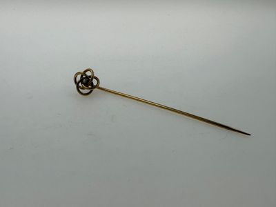 a close up of a small metal object on a white surface