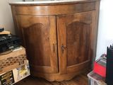 an image of a wooden cabinet with a bust on top of it