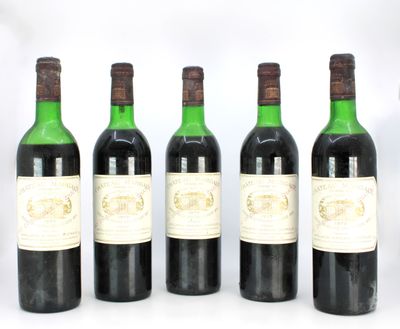four bottles of wine are lined up in a row