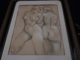 drawing of a couple of nudes in a frame on a table