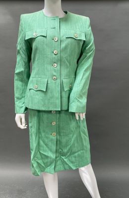 an image of a mannequin dressed in a green suit and skirt