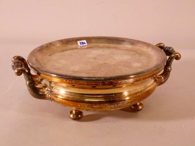 an image of a gold plate with handles on a white surface