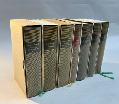 four books are stacked on top of each other on a table