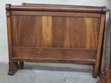 a bed with a wooden headboard and foot board