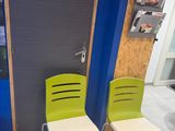 two green chairs sitting next to each other in a room