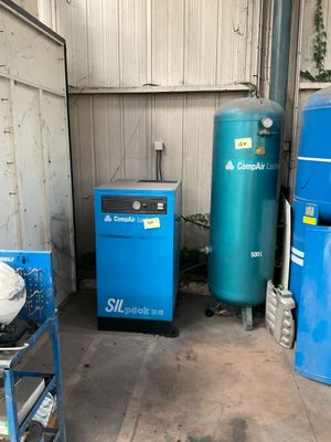 two blue tanks and a blue machine in a garage