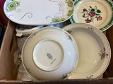 many plates and bowls in a box on the table