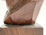 sculpture of a bust of a man on a wooden base