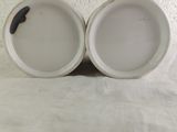 two cups that are sitting next to each other on a table