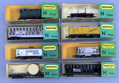 many different train cars in the box on the table