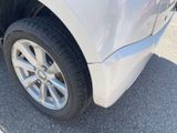a close up of a car ' s tire on the pavement