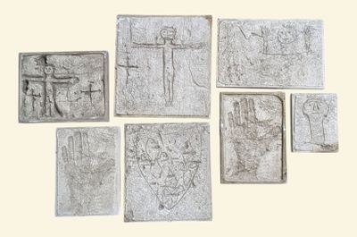 several pieces of stone with carvings on them on a white surface