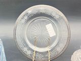 three glass vases and a glass plate on a table